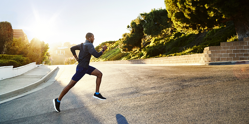 man-running-on-road-with-sunlight